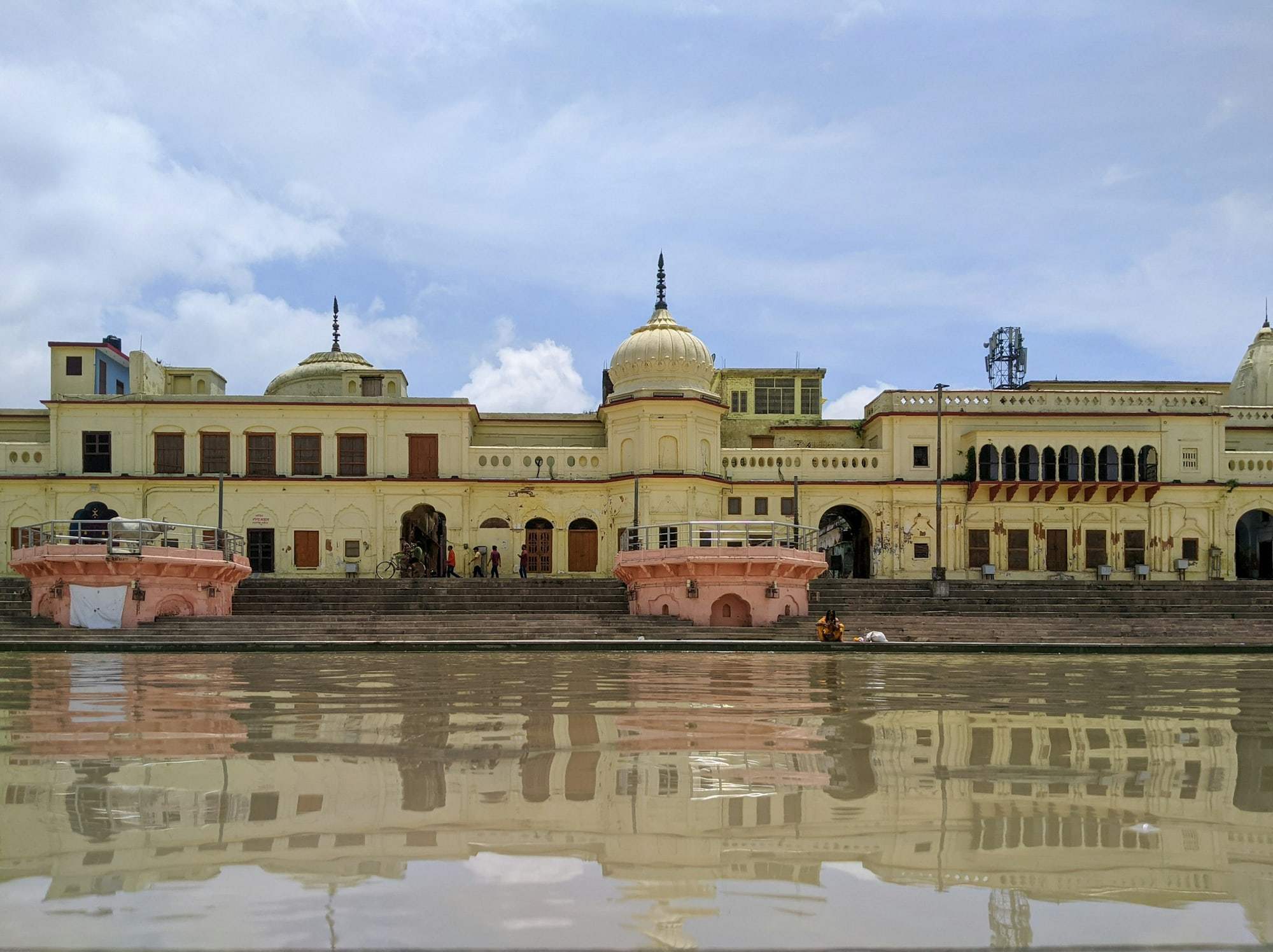 Domed riverside buildings reflected in still water in Ayodhya